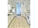 Bright kitchen with white appliances, ample counter space, and tiled floor at 5217 Snowy Heron Dr, Lakeland, FL 33812