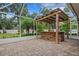 Outdoor kitchen with stone countertop and covered patio area at 6529 Longwood Trace S Ln, Lakeland, FL 33811