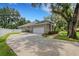 Single car garage with long driveway and mature trees at 6529 Longwood Trace S Ln, Lakeland, FL 33811