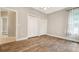 Bedroom with wood-look tile flooring and double door closet at 6529 Longwood Trace S Ln, Lakeland, FL 33811