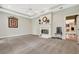 Gathering room with fireplace, ceiling fan, and carpet flooring at 6529 Longwood Trace S Ln, Lakeland, FL 33811