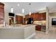 Spacious kitchen with dark wood cabinets, stainless steel appliances, and a large island at 6529 Longwood Trace S Ln, Lakeland, FL 33811