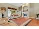 Bright living room featuring hardwood floors, a fireplace, and ample natural light at 6529 Longwood Trace S Ln, Lakeland, FL 33811