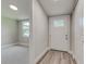 Bright entryway with white door and wood-look flooring at 2529 Weber St, Lakeland, FL 33801