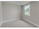 Simple bedroom with grey walls, carpet, and a window at 2529 Weber St, Lakeland, FL 33801