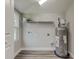 Laundry room with shelving and a new water heater at 2529 Weber St, Lakeland, FL 33801