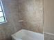 Bathroom with tiled walls and bathtub at 603 Dixon E St, Fort Meade, FL 33841