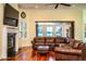 Living room with a fireplace, large windows, and a view of the water at 4848 Island Shores Ln, Lakeland, FL 33809