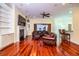 Living room with hardwood floors, built-in shelving, and a fireplace at 4848 Island Shores Ln, Lakeland, FL 33809