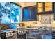 Stainless steel grill and granite countertops in this outdoor kitchen at 4848 Island Shores Ln, Lakeland, FL 33809