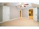 Bedroom with carpet flooring, ceiling fan and access to other rooms at 4848 Island Shores Ln, Lakeland, FL 33809