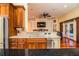 Kitchen features granite counters, island, and views into Gathering room at 4848 Island Shores Ln, Lakeland, FL 33809