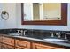Bathroom with double vanity, granite countertop, and dark wood cabinets at 4848 Island Shores Ln, Lakeland, FL 33809