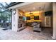 Outdoor kitchen with pizza oven, grill, and bar seating at 4848 Island Shores Ln, Lakeland, FL 33809