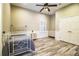 Well-lit bedroom with wood-look floors, ceiling fan, and double doors leading to a walk-in closet at 4848 Island Shores Ln, Lakeland, FL 33809