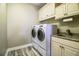 Laundry room with washer, dryer, and built-in cabinets at 4848 Island Shores Ln, Lakeland, FL 33809