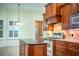 Island kitchen with dark granite and wood cabinets at 4848 Island Shores Ln, Lakeland, FL 33809