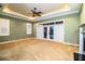 Spacious bedroom with carpet flooring, ceiling fan, and sliding glass doors leading to patio at 4848 Island Shores Ln, Lakeland, FL 33809