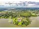 Aerial view of a waterfront estate with lush landscaping and beautiful lake views at 4848 Island Shores Ln, Lakeland, FL 33809