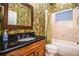 Bathroom with tropical wallpaper, dark vanity, and bathtub at 4848 Island Shores Ln, Lakeland, FL 33809