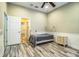 Bedroom with wood-look floors, ceiling fan, and view of hallway at 4848 Island Shores Ln, Lakeland, FL 33809
