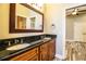 Double vanity bathroom with granite countertop and dark wood cabinets at 4848 Island Shores Ln, Lakeland, FL 33809