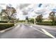 Gated community entrance with stone pillars and landscaping at 4848 Island Shores Ln, Lakeland, FL 33809