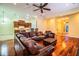 Spacious living room showcasing hardwood floors, a leather sectional sofa and a fireplace at 4848 Island Shores Ln, Lakeland, FL 33809