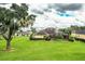Back view of a home with a large covered patio and lush green lawn at 4848 Island Shores Ln, Lakeland, FL 33809