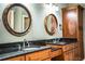 Double vanity bathroom with granite countertop and wood cabinets at 4848 Island Shores Ln, Lakeland, FL 33809