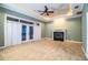 Gathering room with fireplace, water view, and ceiling fan at 4848 Island Shores Ln, Lakeland, FL 33809