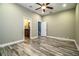Spacious bedroom with wood-look floors, ceiling fan and access to bathroom at 4848 Island Shores Ln, Lakeland, FL 33809