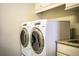 Laundry room with modern washer and dryer, granite countertop, and cabinets at 4848 Island Shores Ln, Lakeland, FL 33809