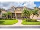 Two-story home with columns, palm trees and manicured lawn at 4848 Island Shores Ln, Lakeland, FL 33809