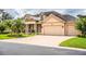 Two-story house featuring a three-car garage and manicured lawn at 4848 Island Shores Ln, Lakeland, FL 33809