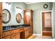 Elegant bathroom with double vanity, granite countertop, and wood cabinets at 4848 Island Shores Ln, Lakeland, FL 33809