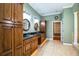 Double vanity bathroom with granite countertop, wood cabinets, and large mirrors at 4848 Island Shores Ln, Lakeland, FL 33809