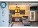 Outdoor kitchen with dark wood cabinets, granite counters & stonework at 4848 Island Shores Ln, Lakeland, FL 33809