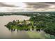 Luxury waterfront home with expansive lake views and lush landscaping at 4848 Island Shores Ln, Lakeland, FL 33809