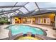 Relaxing pool and spa area with a covered lanai and outdoor kitchen at 4848 Island Shores Ln, Lakeland, FL 33809
