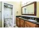 Double vanity bathroom with granite countertop and dark wood cabinets at 4848 Island Shores Ln, Lakeland, FL 33809