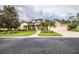 Two-story house with a three-car garage and lush landscaping at 4848 Island Shores Ln, Lakeland, FL 33809