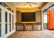 Outdoor kitchen with brickwork, stainless steel appliances, and a ceiling fan at 4848 Island Shores Ln, Lakeland, FL 33809