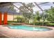Pool and spa with covered patio and orange curtains at 4848 Island Shores Ln, Lakeland, FL 33809