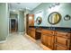Double vanity bathroom with granite countertop and wood cabinets at 4848 Island Shores Ln, Lakeland, FL 33809
