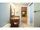 Bathroom with granite countertop, wood vanity, and a view of another room at 4848 Island Shores Ln, Lakeland, FL 33809