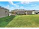 Spacious backyard with a large grassy area and home view at 4756 Acorn Dr, Mulberry, FL 33860
