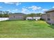 Large backyard with spacious lawn, detached garage, and basketball court at 4756 Acorn Dr, Mulberry, FL 33860