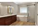 Elegant bathroom with double vanity, soaking tub, and walk-in shower at 4756 Acorn Dr, Mulberry, FL 33860