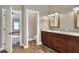 Bathroom features double vanity, granite countertop and views into other rooms at 4756 Acorn Dr, Mulberry, FL 33860